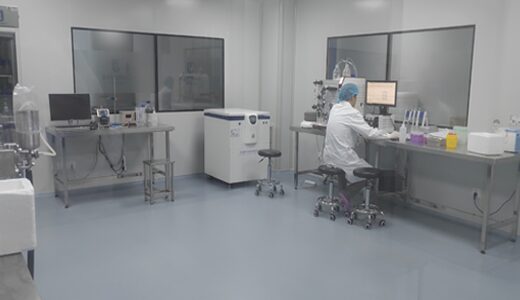 Laboratory with instruments and a technician at a bench